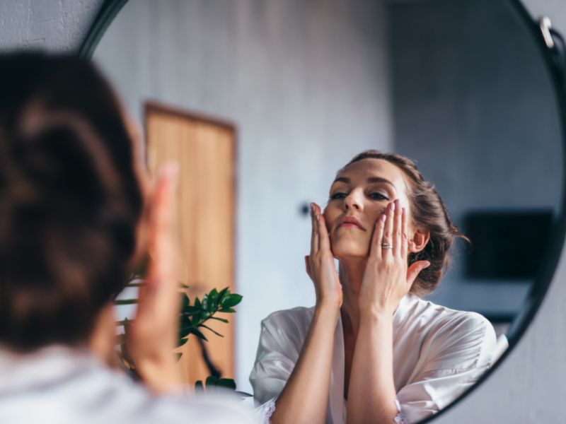 A lady gently massaging her face