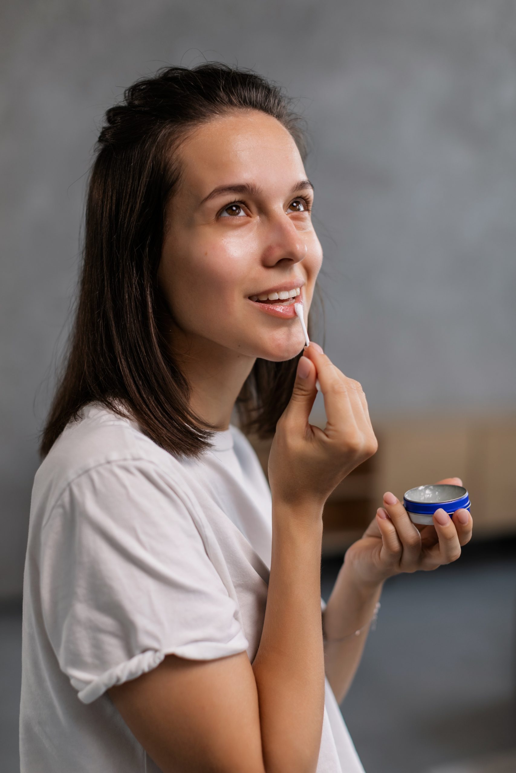 Girl applying lip balm