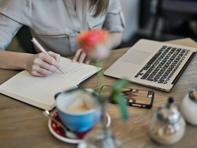 A lady writing her thoughts in a journal